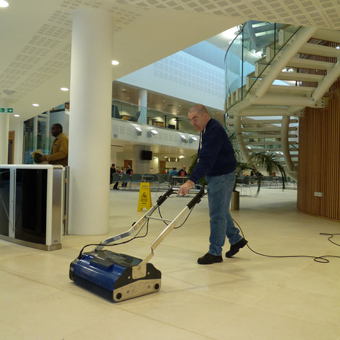 Professional efficiently operating the Duplex 620 Floor Cleaner in a large office headquarters, showcasing its exceptional cleaning performance and versatility in diverse commercial environments
