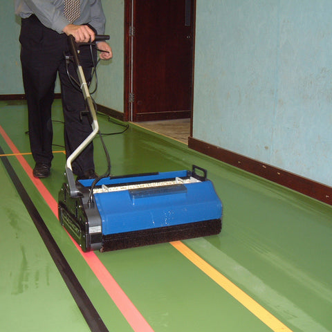 Gentleman effortlessly maneuvering the Duplex 620 Floor Cleaner in a sports hall, demonstrating its efficiency and effectiveness in large commercial spaces