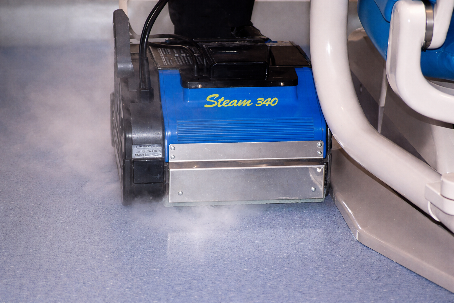 Duplex 340 steam cleaner working along carpet edges and tight floor areas
