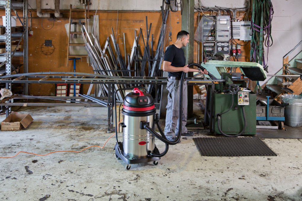 LSU375 industrial wet vacuum cleaner in use inside a workshop collecting wet debris