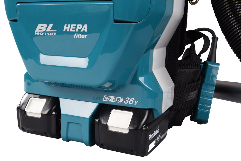 Close-up of Makita DVC261TX25 18V LXT battery system on cordless backpack vacuum
