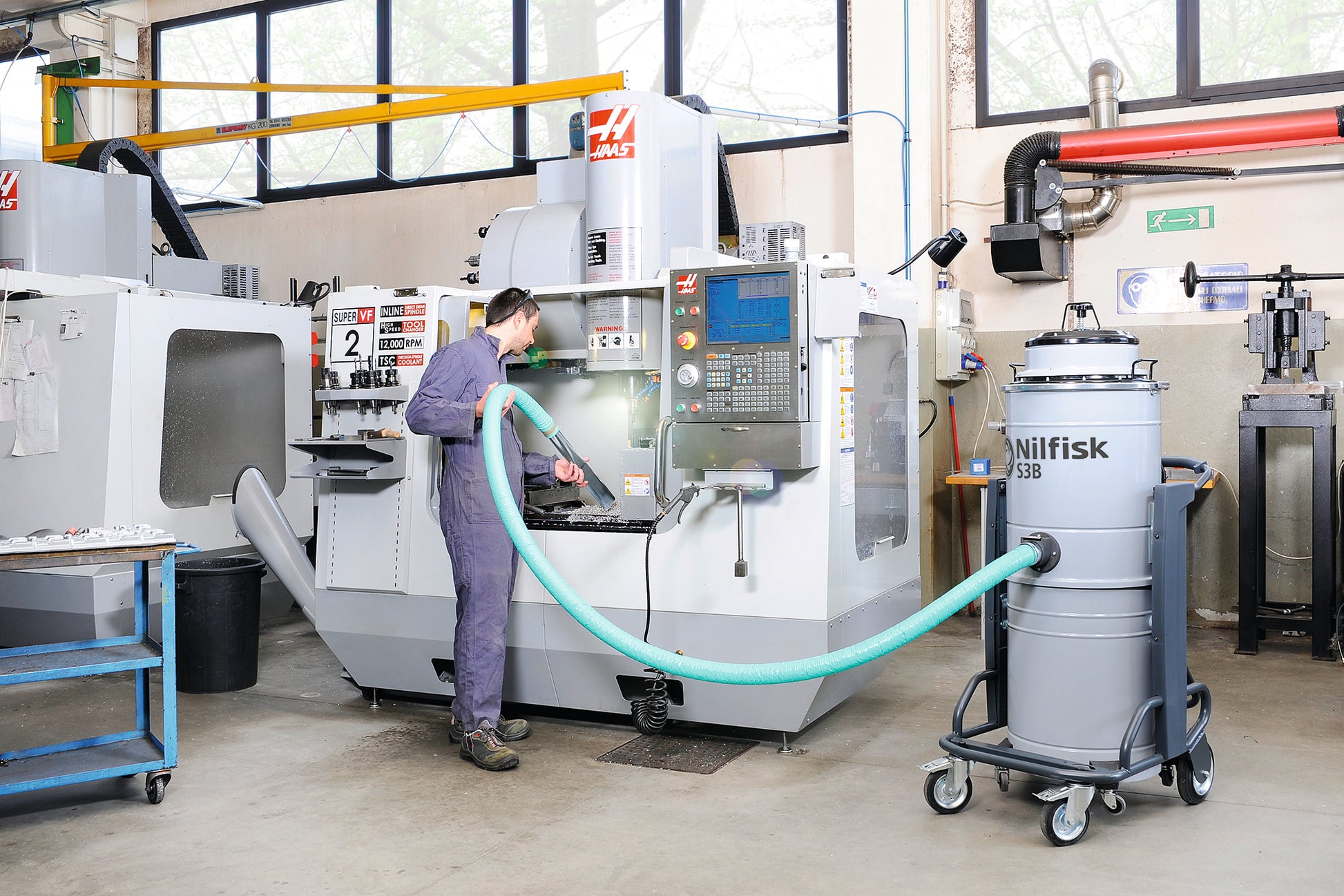 Nilfisk S3B L100 vacuum operating in a manufacturing or production facility