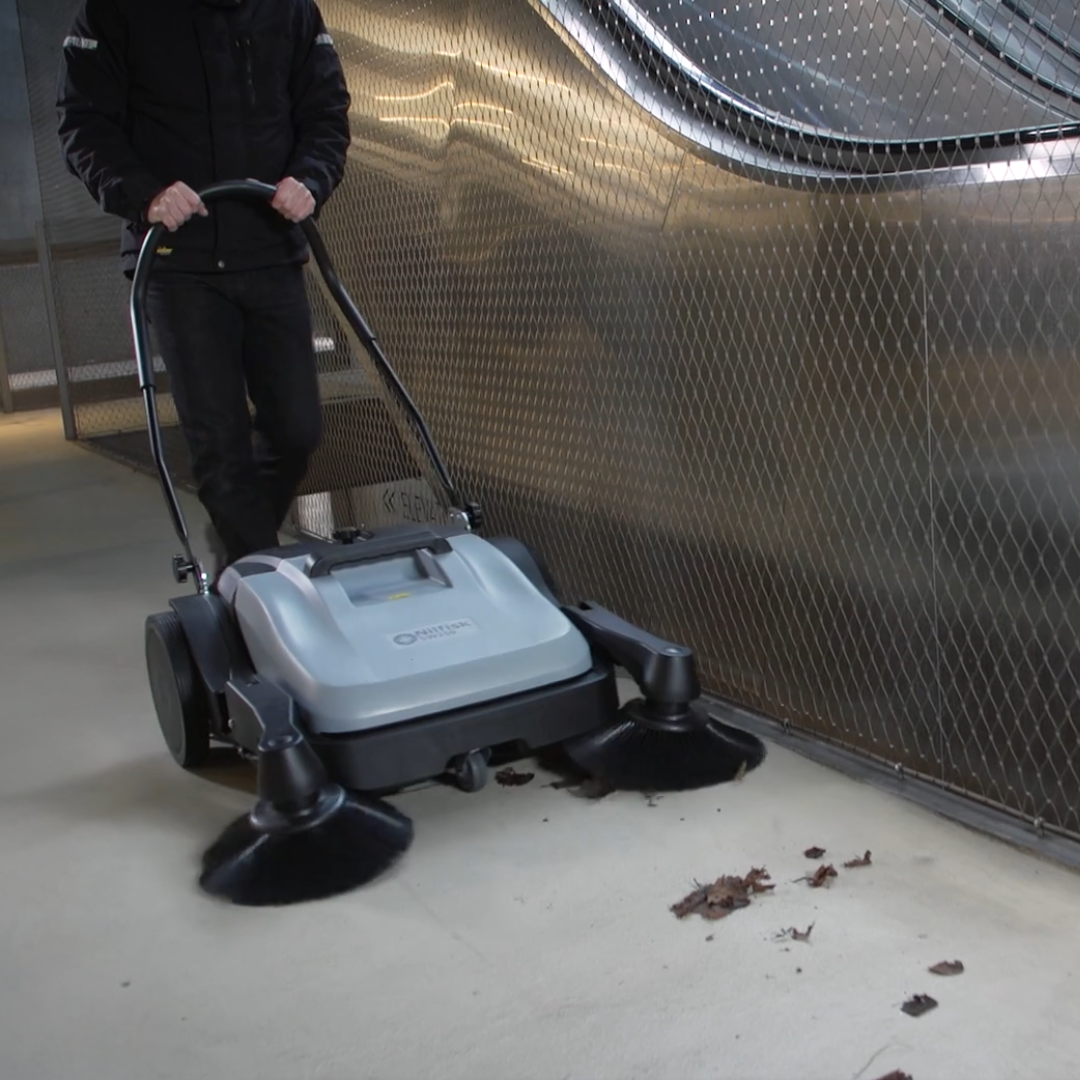 Nilfisk SW250 manual sweeper cleaning outdoor pathways and forecourts efficiently