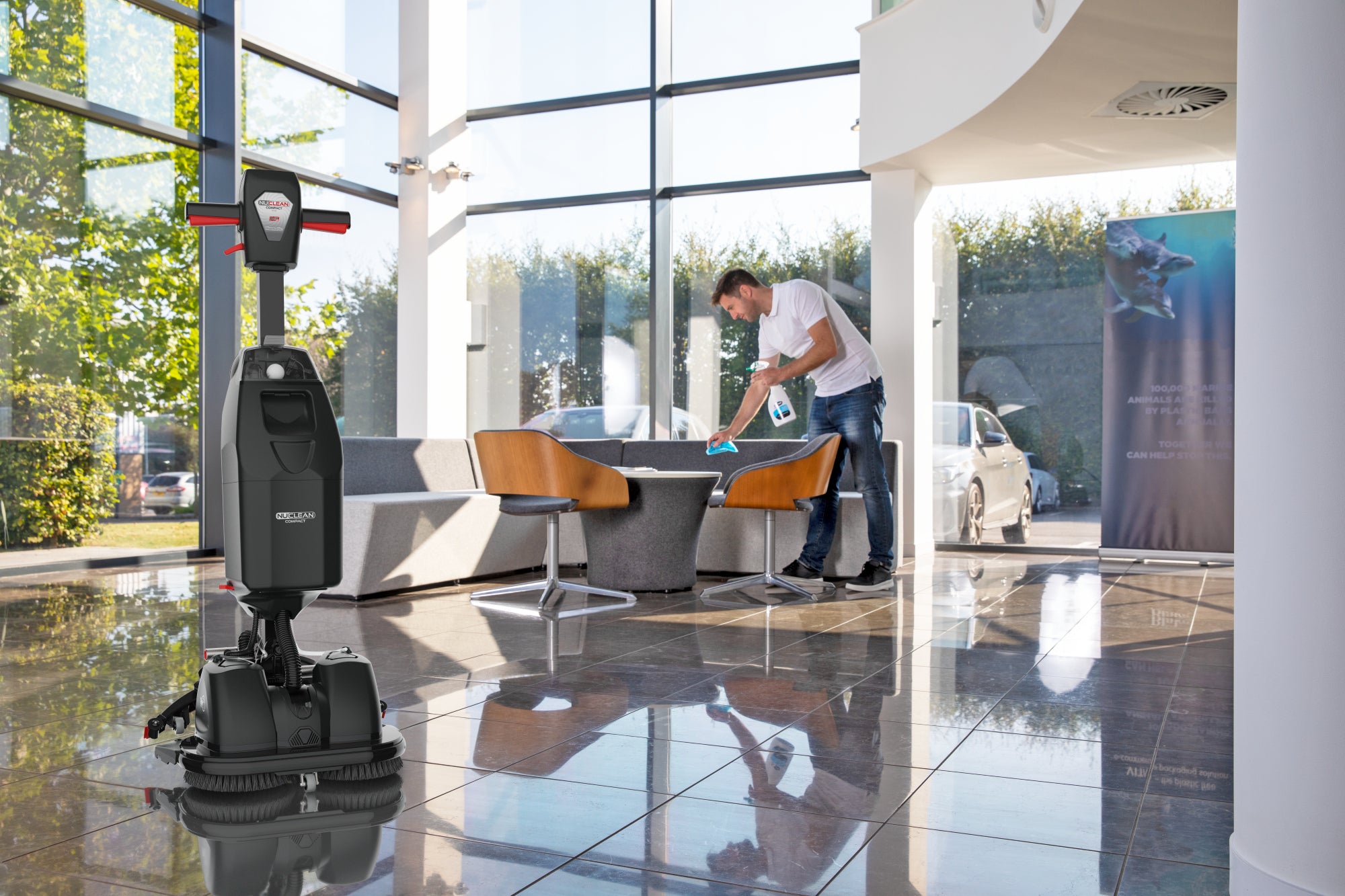 Numatic 440NX upright scrubber dryer being used for commercial hard floor cleaning in public areas