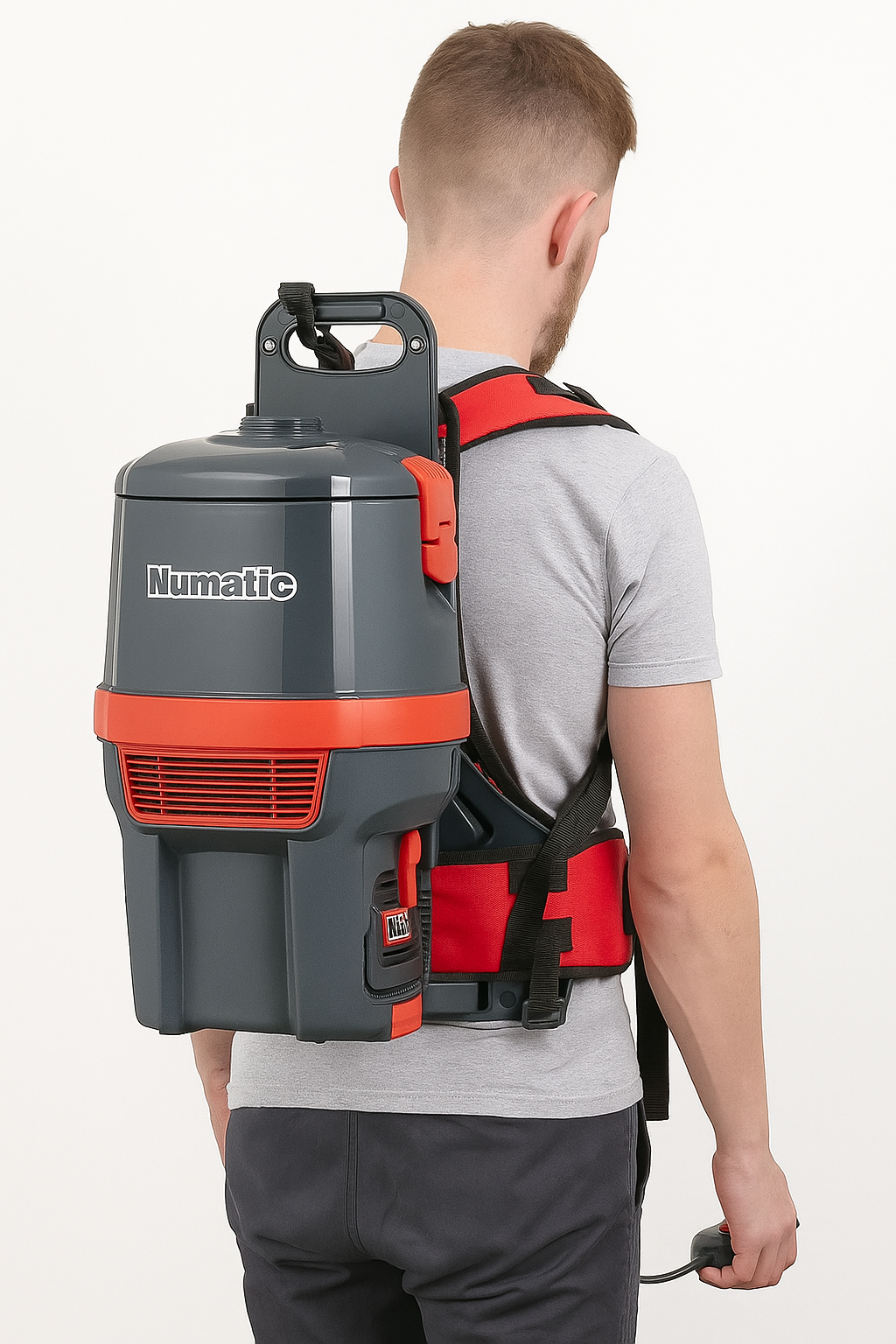 Operator using Numatic RSB150NX cordless backpack vacuum cleaner for efficient commercial cleaning