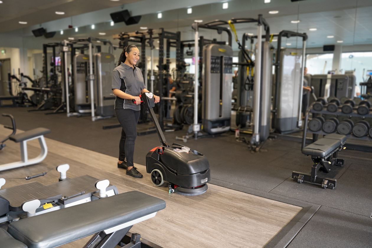Numatic TTB1840NX battery scrubber dryer in use in commercial cleaning environment