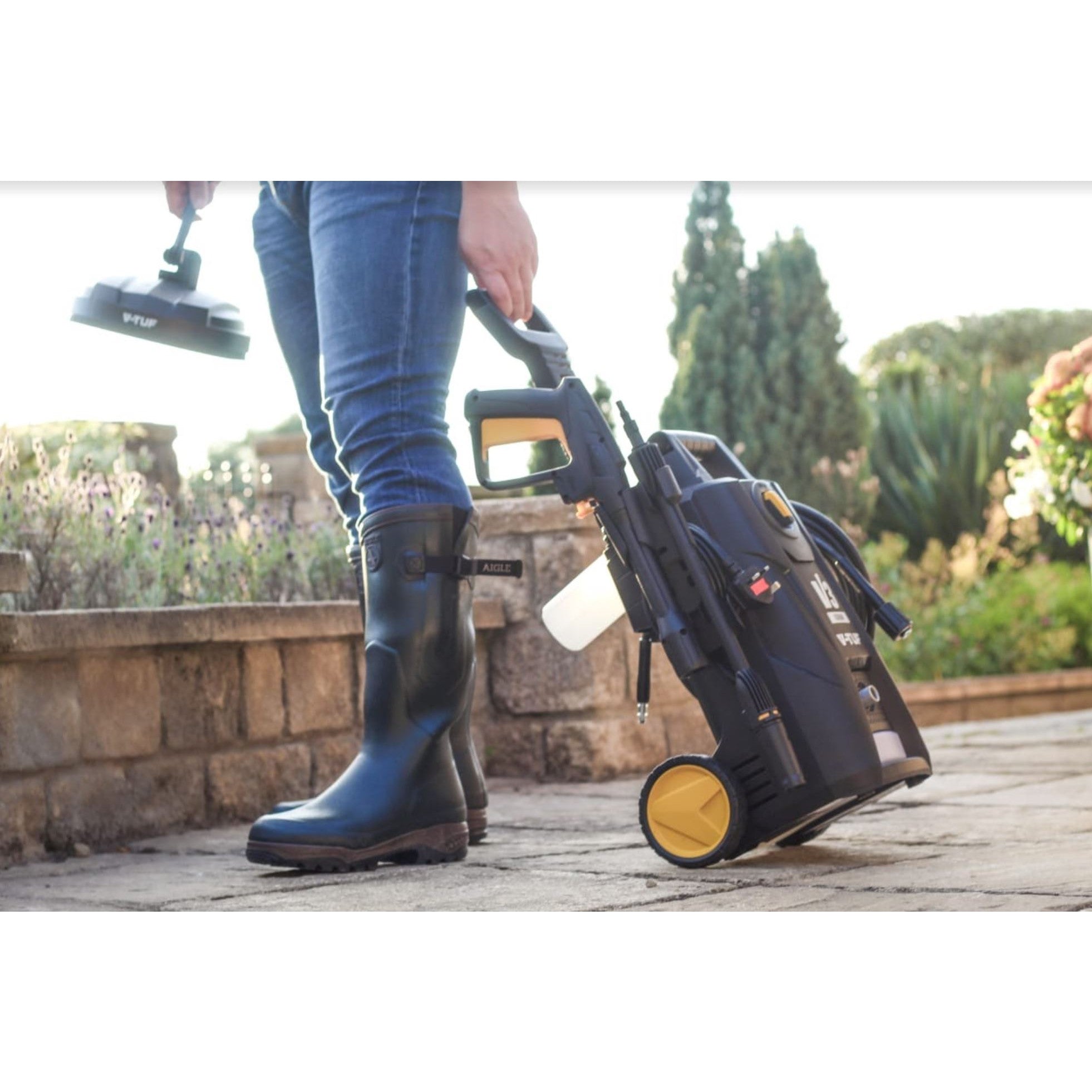 Operator using V-TUF V2 jet wash with patio cleaner attachment for outdoor surface cleaning