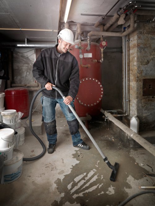 Nilfisk Attix 30-01 PC being used for heavy-duty industrial cleaning tasks