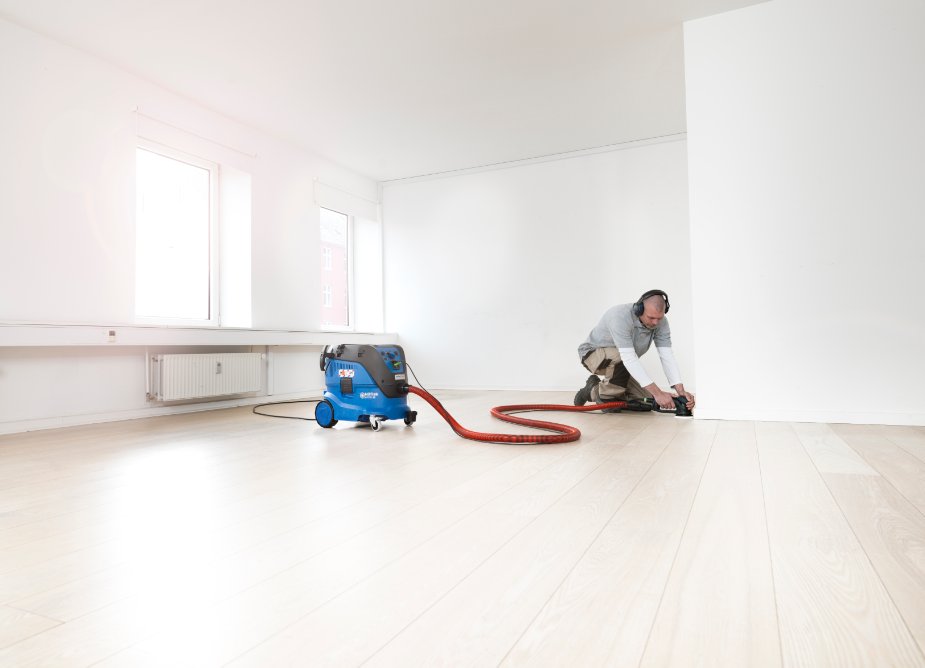 Nilfisk Attix 33-2M PC M-Class vacuum cleaner being used indoors for fine dust removal and surface cleaning