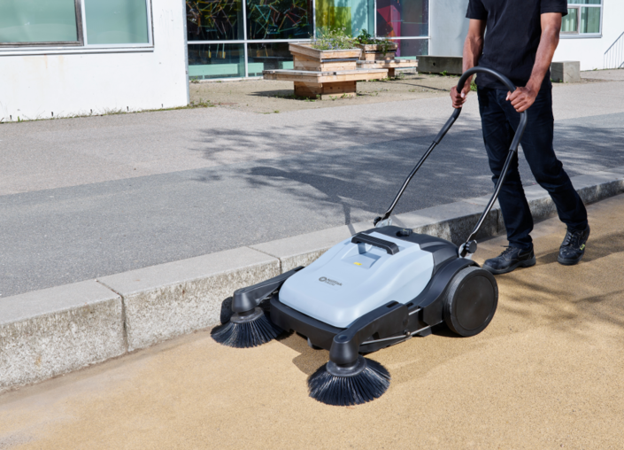 Nilfisk SW250 manual sweeper cleaning outdoor pathways and forecourts efficiently