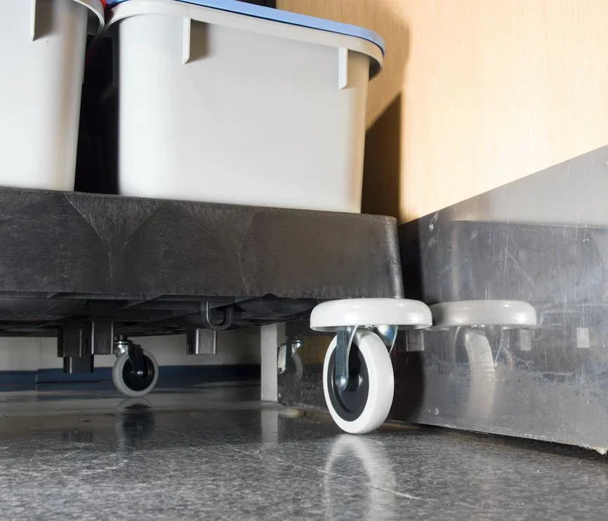 Close-up of heavy-duty castor wheels on Numatic EM2 ECO-Matic cleaning trolley