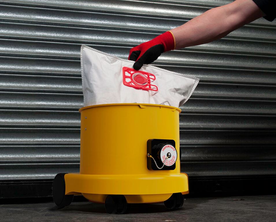 Operator using Numatic HZ200 hazardous dust vacuum for site cleanup and dust extraction