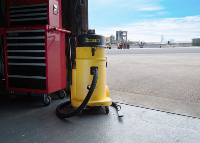 Numatic HZD900 vacuum used outdoors on construction or loading bay area for hazardous dust extraction