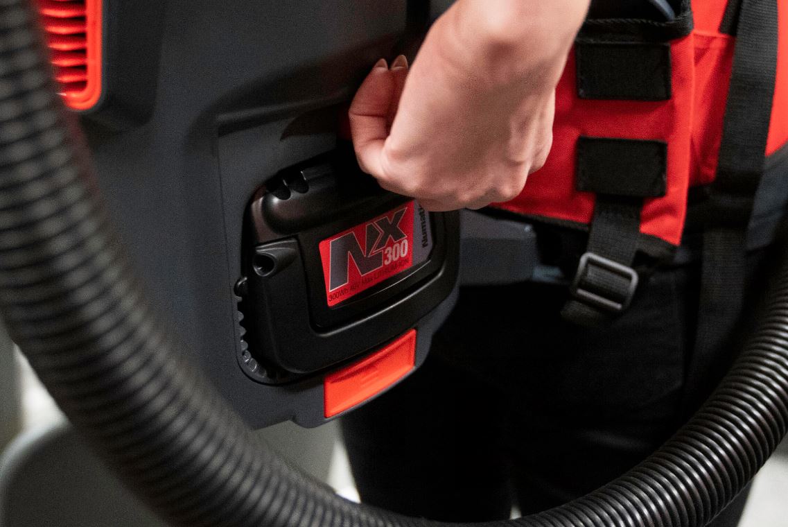 Close-up of NX300 lithium battery being inserted into Numatic RSB150NX cordless backpack vacuum